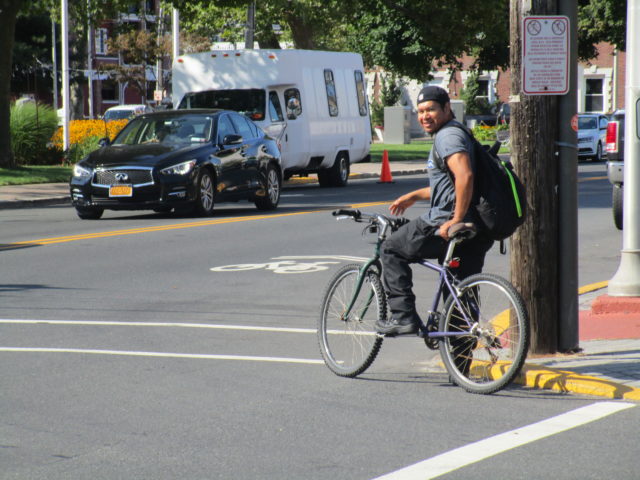 Latino man bike lane